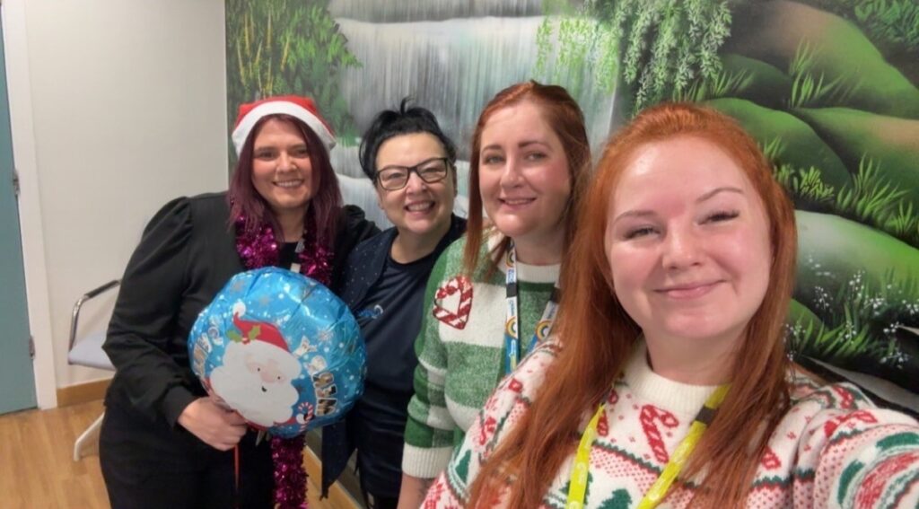 Holly Cooper with colleagues at a Christmas celebration